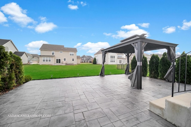 view of patio / terrace featuring a gazebo and a residential view