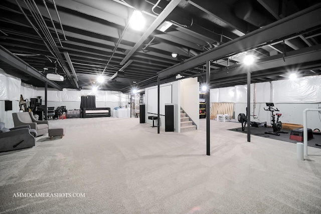 finished below grade area featuring carpet flooring and stairway