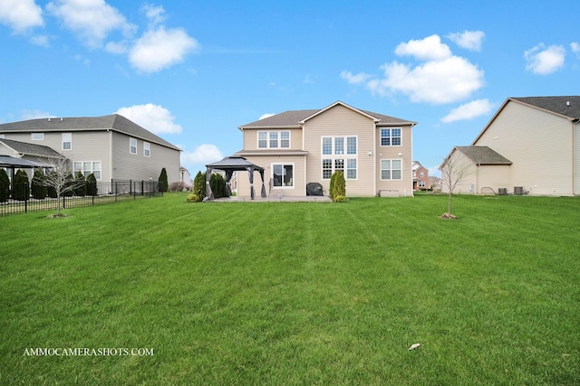 back of house with a gazebo, a patio area, fence, and a lawn
