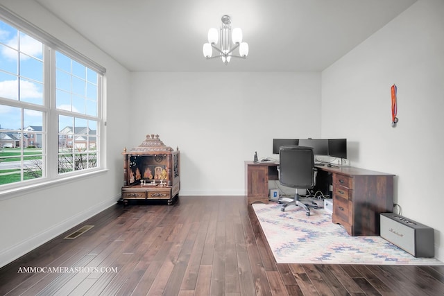 office area with dark wood-style flooring, visible vents, baseboards, and a chandelier