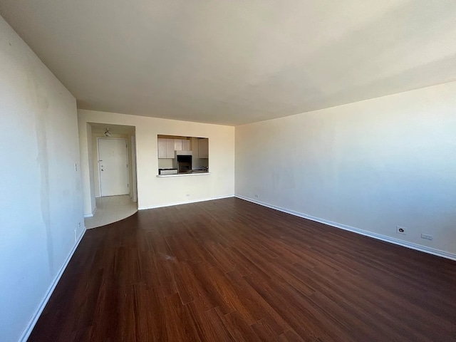 1150 N Lake Shore Dr Unit 17G, Chicago, IL 60611 - unfurnished living room with dark wood-type flooring and baseboards