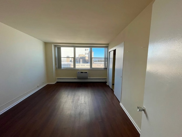 1150 N Lake Shore Dr Unit 17G, Chicago, IL 60611 - unfurnished room featuring dark wood-style flooring, a baseboard heating unit, and baseboards