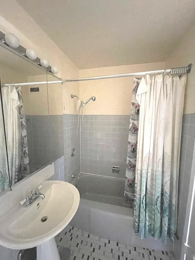 1150 N Lake Shore Dr Unit 17G, Chicago, IL 60611 - bathroom featuring tile walls, shower / bath combo, tile patterned floors, and a sink