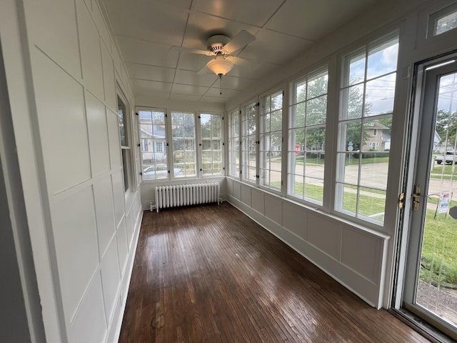 211 W 13th St, Sterling, IL 61081 - unfurnished sunroom featuring radiator heating unit, a decorative wall, healthy amount of natural light, and wood-type flooring