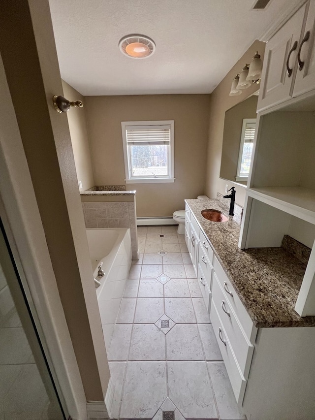 211 W 13th St, Sterling, IL 61081 - bathroom with vanity, a garden tub, toilet, tile patterned flooring, and a baseboard radiator