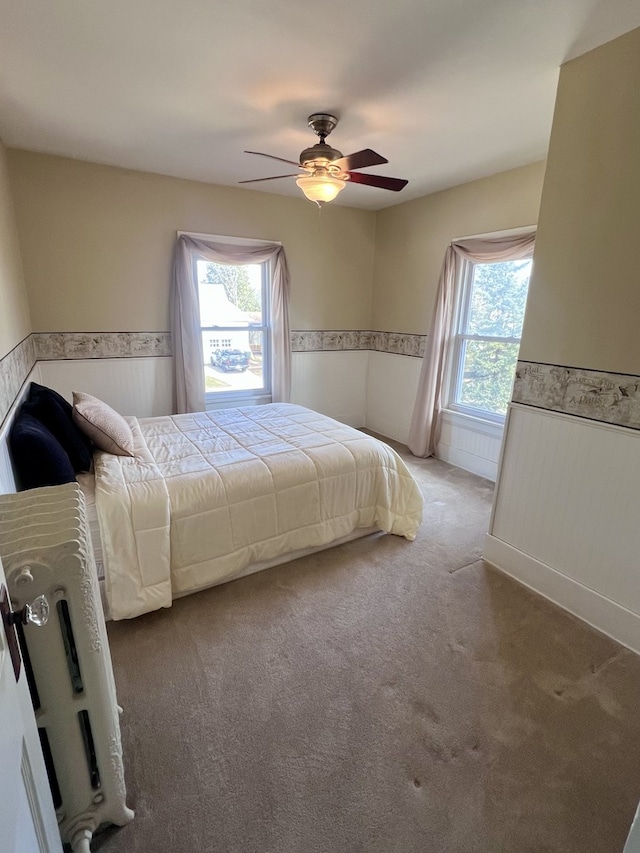 211 W 13th St, Sterling, IL 61081 - bedroom with wainscoting, multiple windows, carpet flooring, and ceiling fan