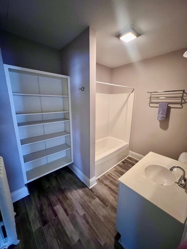 211 W 13th St, Sterling, IL 61081 - full bathroom featuring wood finished floors, tub / shower combination, baseboards, and vanity