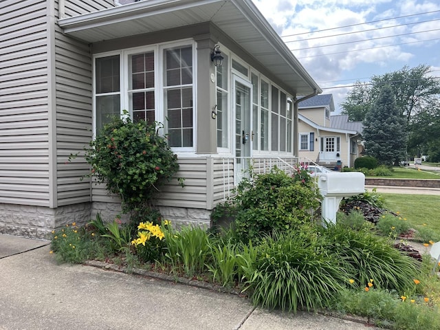 211 W 13th St, Sterling, IL 61081 - view of side of home with a sunroom
