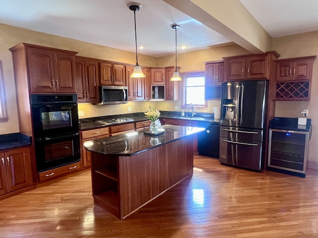 211 W 13th St, Sterling, IL 61081 - kitchen featuring appliances with stainless steel finishes, a sink, open shelves, light wood finished floors, and hanging light fixtures
