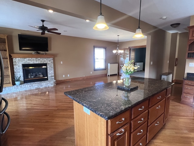 211 W 13th St, Sterling, IL 61081 - kitchen with radiator heating unit, a ceiling fan, open floor plan, and light wood finished floors