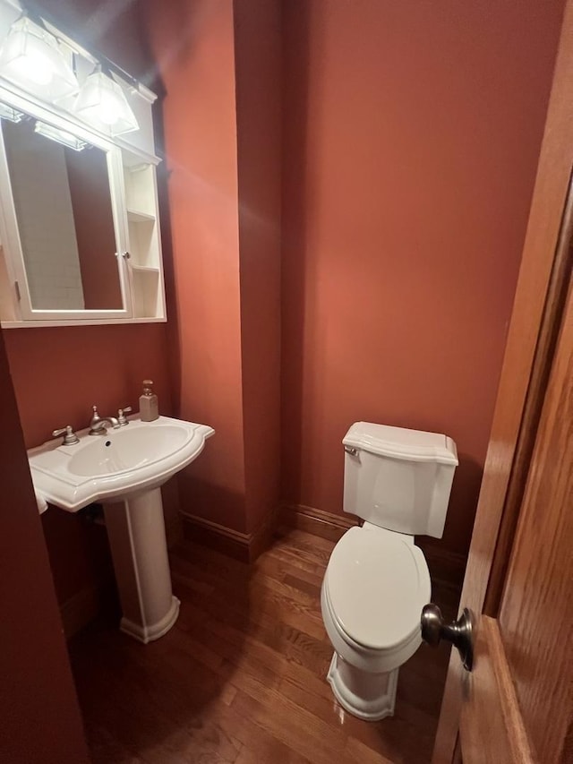 211 W 13th St, Sterling, IL 61081 - bathroom with wood finished floors, toilet, and baseboards