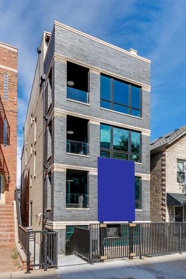 view of building exterior with a fenced front yard