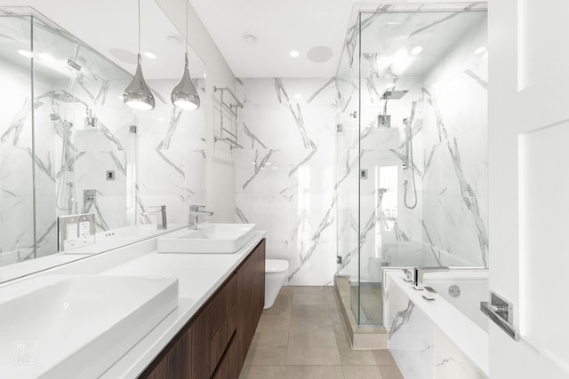 full bath featuring a marble finish shower, toilet, double vanity, and tile patterned floors