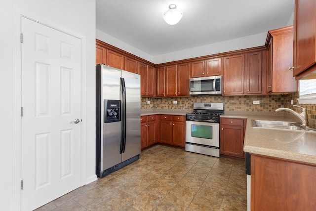 3576 Gabrielle Ln, Aurora, IL 60504 - kitchen with stainless steel appliances, a sink, decorative backsplash, light countertops, and brown cabinets
