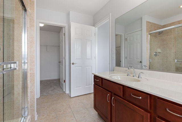 3576 Gabrielle Ln, Aurora, IL 60504 - bathroom with a shower stall, a spacious closet, tile patterned flooring, and vanity