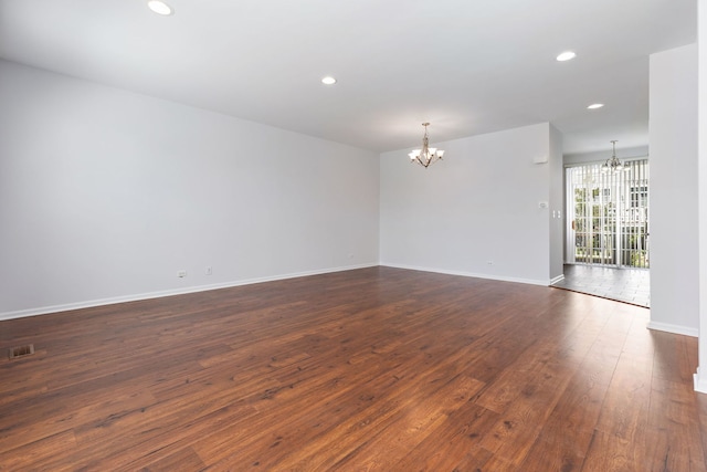 3576 Gabrielle Ln, Aurora, IL 60504 - spare room with a chandelier, dark wood finished floors, recessed lighting, and baseboards