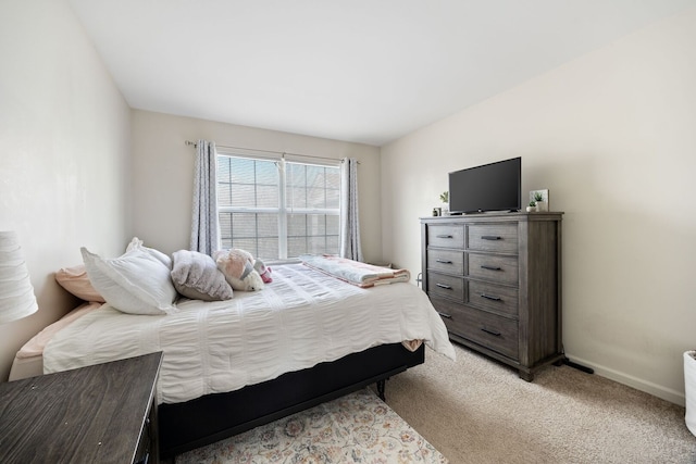 bedroom featuring baseboards and light carpet