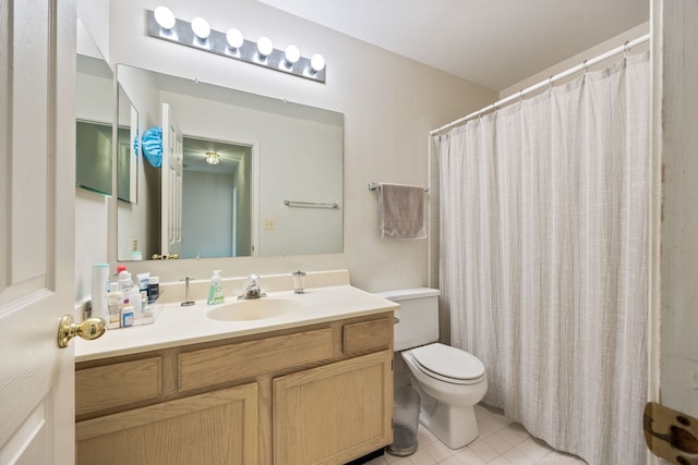 bathroom featuring a shower with shower curtain, toilet, tile patterned flooring, and vanity