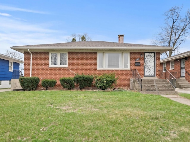 339 Clyde Ave, Calumet City, IL 60409 - view of front of home with a chimney, a front yard, brick siding, and roof with shingles