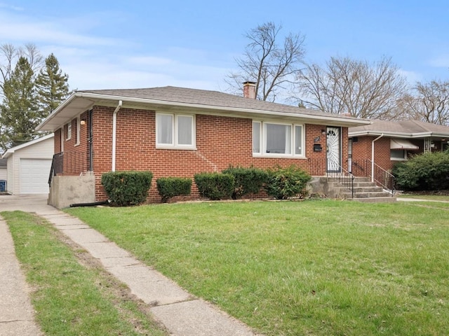 339 Clyde Ave, Calumet City, IL 60409 - view of front of home with roof with shingles, a chimney, an outdoor structure, brick siding, and a front lawn