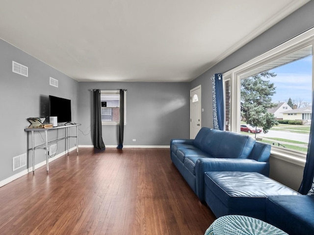 339 Clyde Ave, Calumet City, IL 60409 - living room with baseboards, visible vents, wood finished floors, and plenty of natural light
