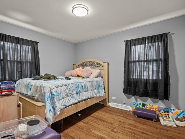 339 Clyde Ave, Calumet City, IL 60409 - bedroom with baseboards, visible vents, and wood finished floors