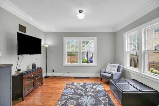 708 W Church St, Champaign, IL 61820 - sitting room featuring healthy amount of natural light, crown molding, and light wood finished floors