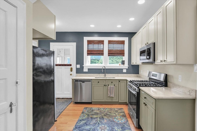 708 W Church St, Champaign, IL 61820 - kitchen with stainless steel appliances, light countertops, light wood-style flooring, recessed lighting, and green cabinets