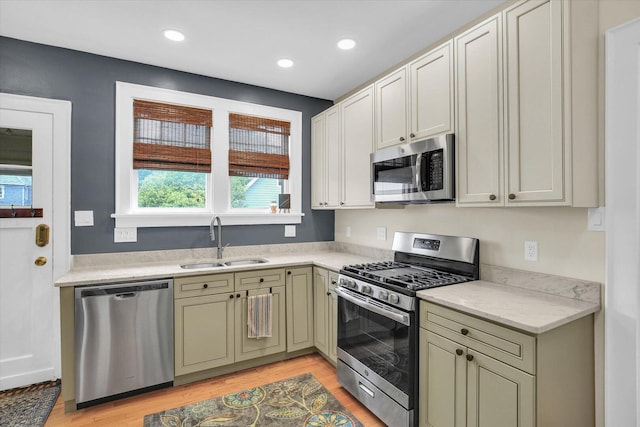 708 W Church St, Champaign, IL 61820 - kitchen featuring appliances with stainless steel finishes, light countertops, light wood-style floors, and recessed lighting