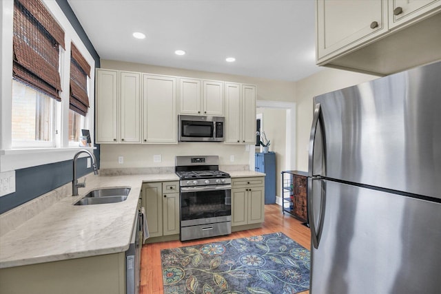 708 W Church St, Champaign, IL 61820 - kitchen featuring stainless steel appliances, recessed lighting, light wood-type flooring, and light stone counters