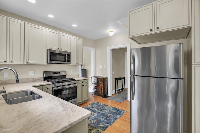 708 W Church St, Champaign, IL 61820 - kitchen featuring stainless steel appliances, recessed lighting, light wood-style flooring, and light stone countertops