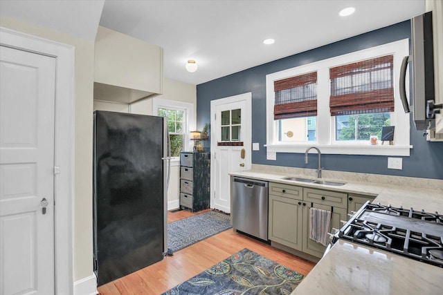 708 W Church St, Champaign, IL 61820 - kitchen featuring appliances with stainless steel finishes, light countertops, light wood finished floors, and recessed lighting