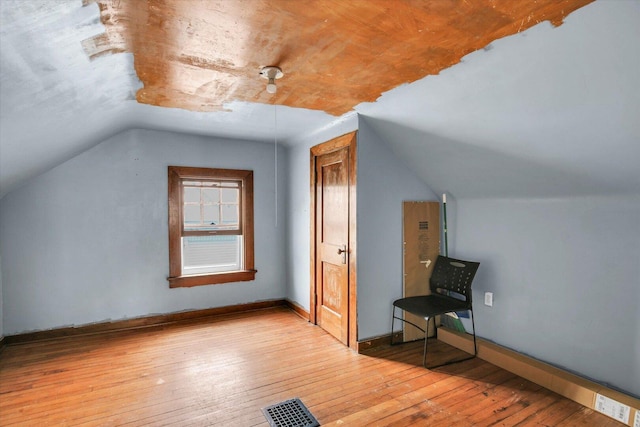 708 W Church St, Champaign, IL 61820 - bonus room featuring vaulted ceiling and hardwood / wood-style flooring
