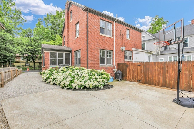 708 W Church St, Champaign, IL 61820 - back of property featuring brick siding, a patio area, and a sunroom