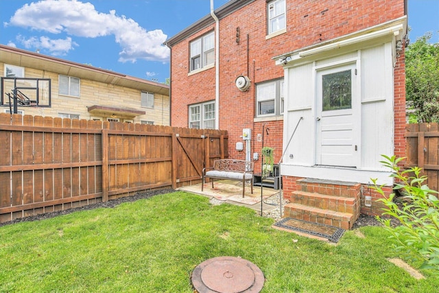 708 W Church St, Champaign, IL 61820 - back of property featuring entry steps, a fenced backyard, brick siding, and a patio area
