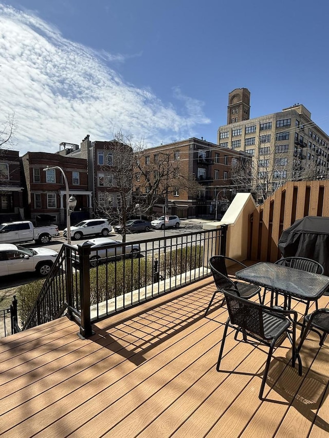 wooden terrace featuring a grill