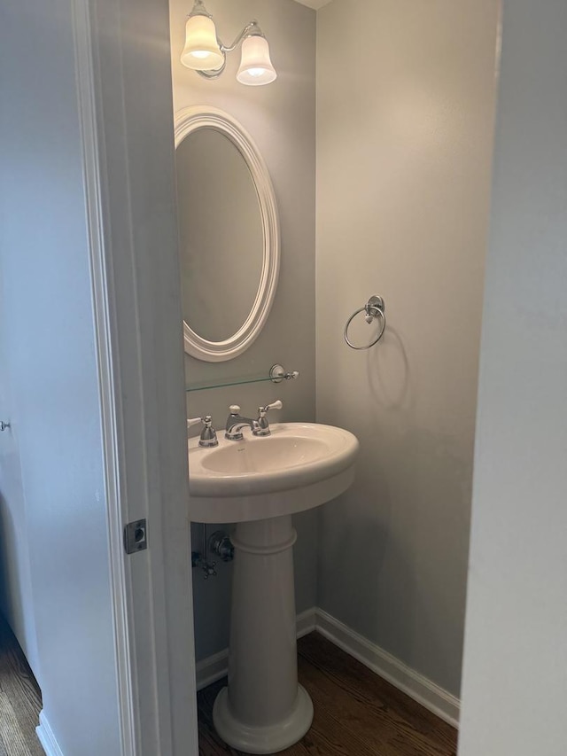 bathroom featuring baseboards and wood finished floors