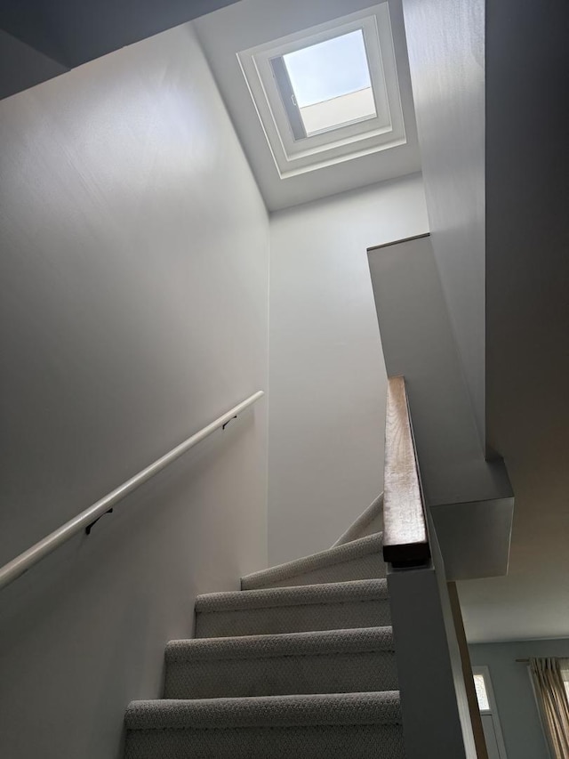 staircase featuring a skylight