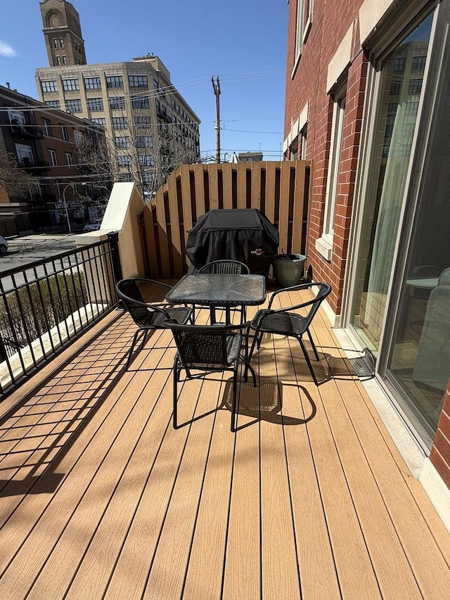 wooden terrace with grilling area and outdoor dining space