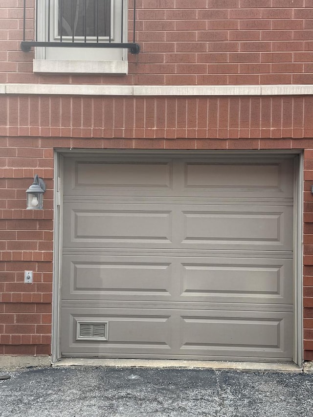 garage featuring aphalt driveway