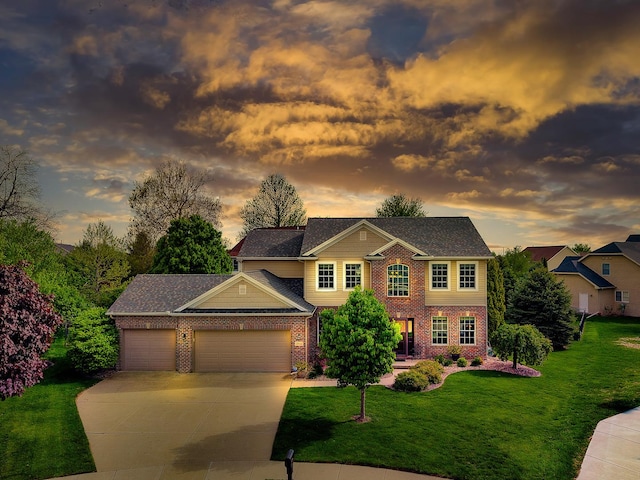 colonial home with an attached garage, brick siding, driveway, and a front lawn