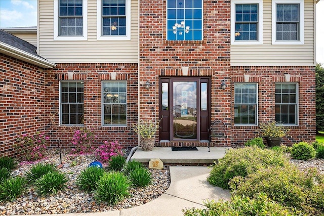 doorway to property with brick siding