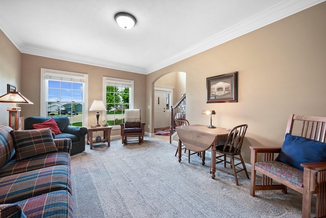 living room with baseboards, stairs, crown molding, arched walkways, and carpet floors