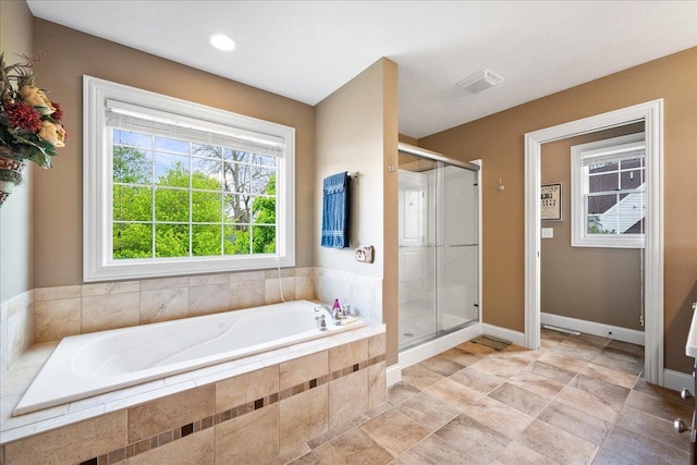 full bath with a stall shower, baseboards, a bath, and visible vents