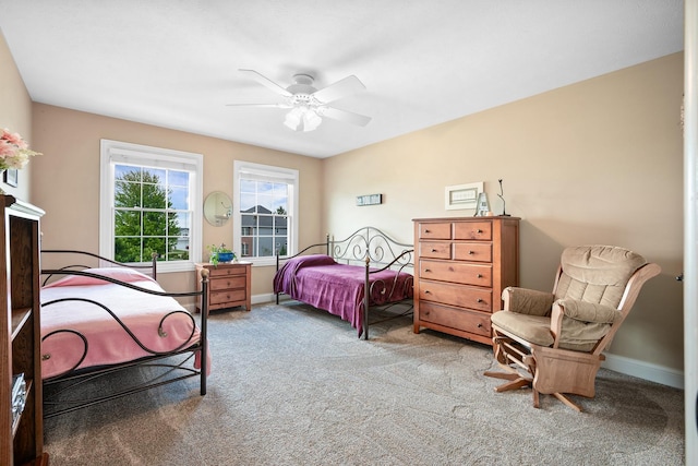 carpeted bedroom featuring ceiling fan and baseboards