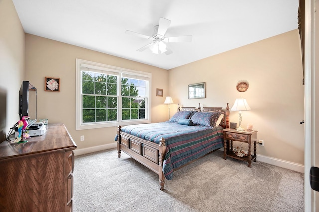 carpeted bedroom with baseboards and a ceiling fan
