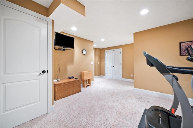 exercise room with baseboards, recessed lighting, and carpet