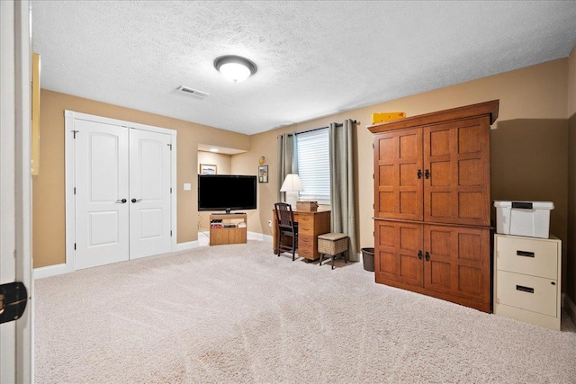 interior space featuring baseboards, visible vents, and carpet