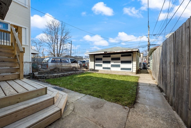 view of yard with fence and an outdoor structure