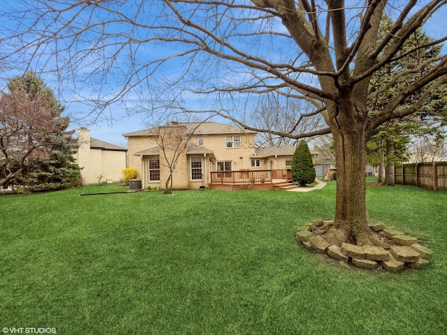 view of yard with a deck, central AC, and fence